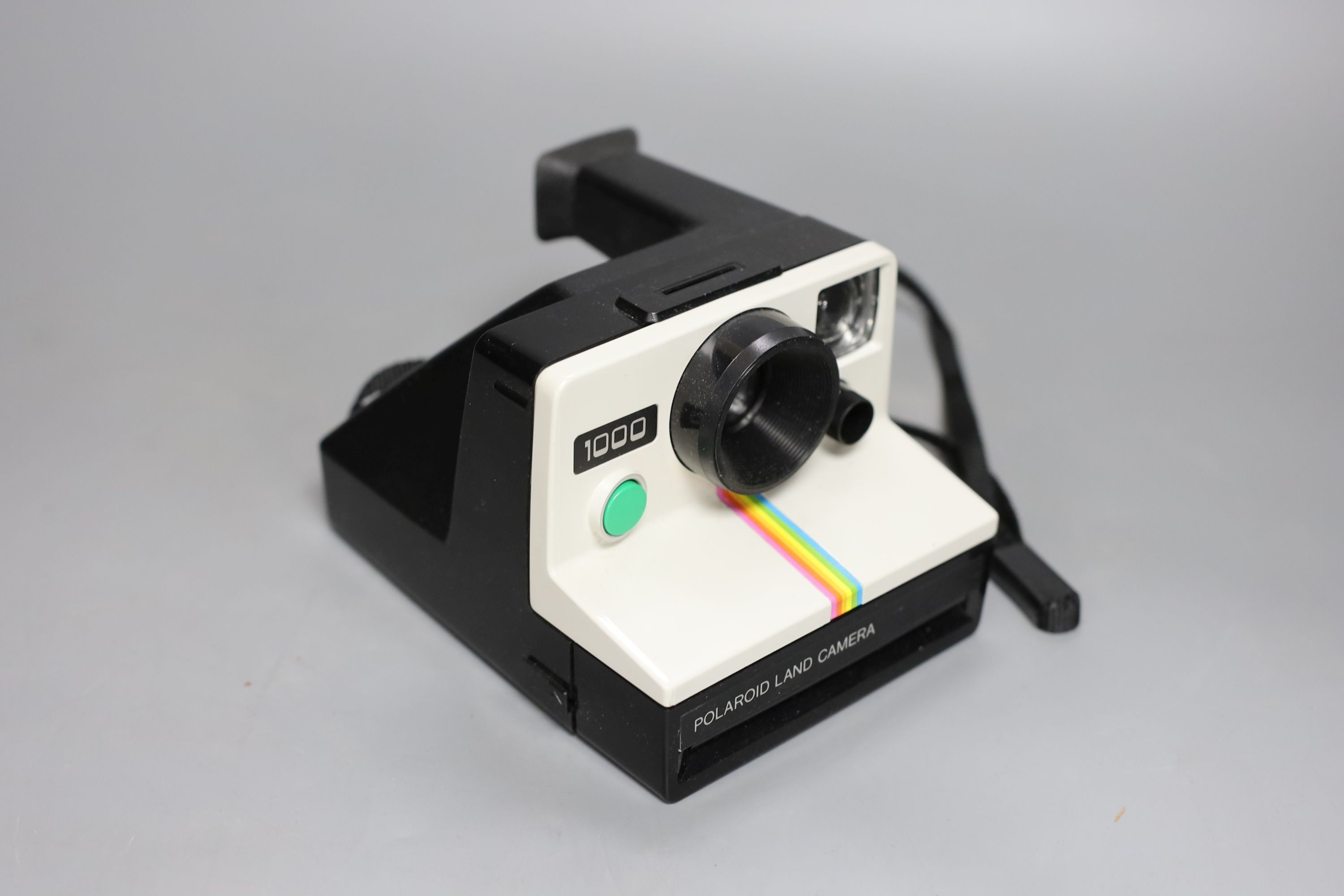 A Polaroid 'card' camera in brown leather case